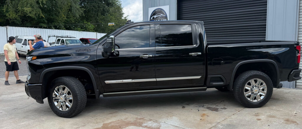 Black pickup truck with full window tint