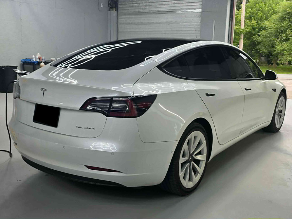 White Tesla with tinted windows in the studio
