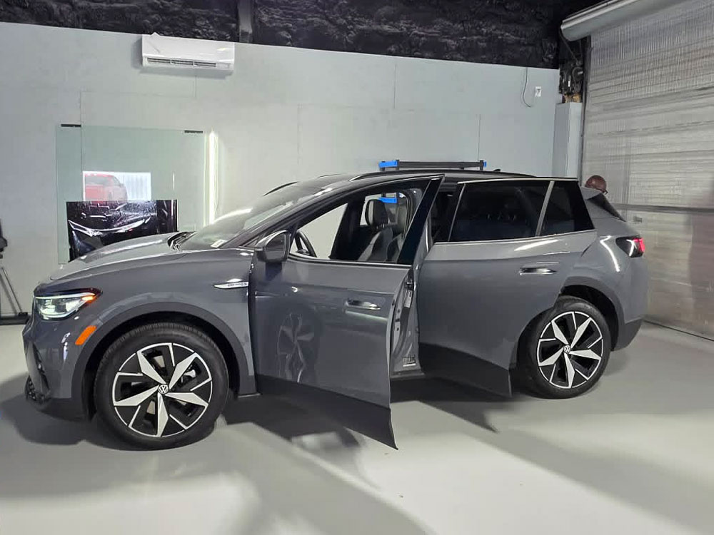 SUV with doors open for a final inspection in the studio