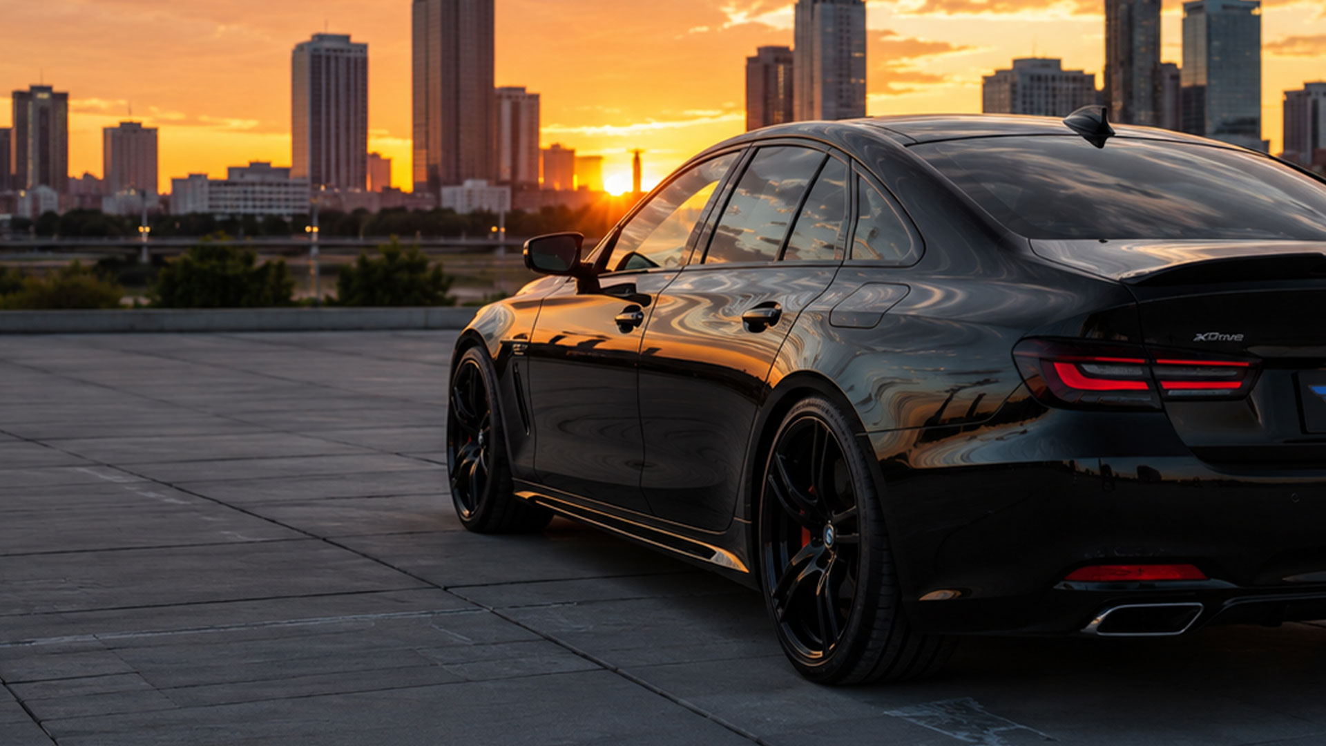 Tinted car at night with city lights behind it