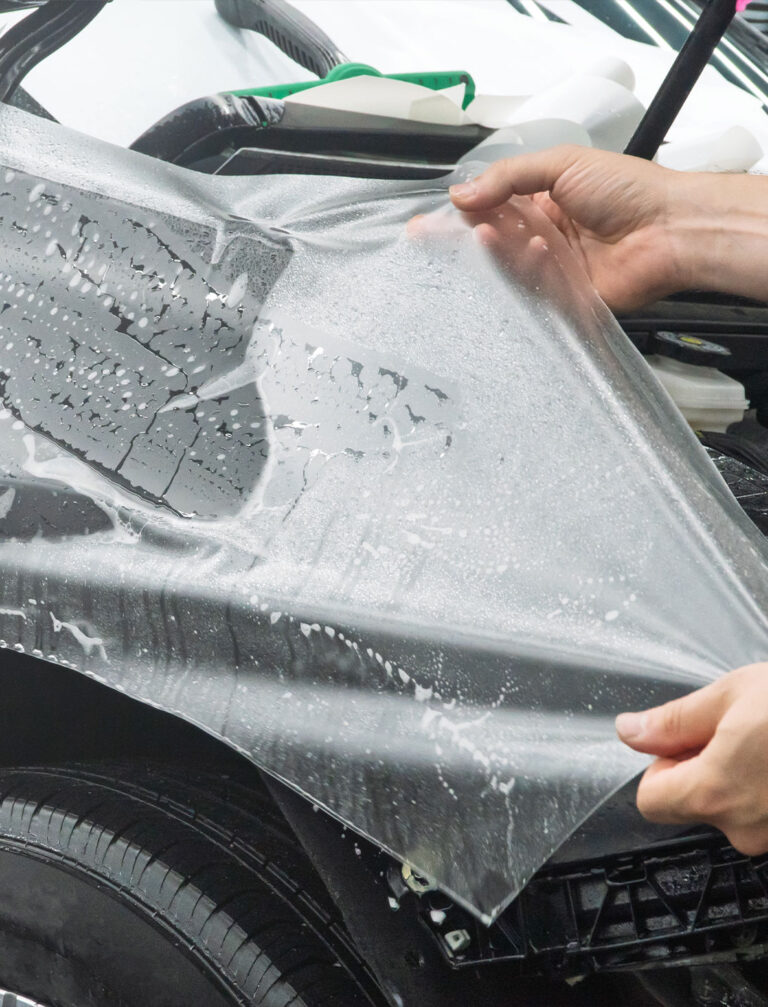 Paint protection film being applied to a vehicle