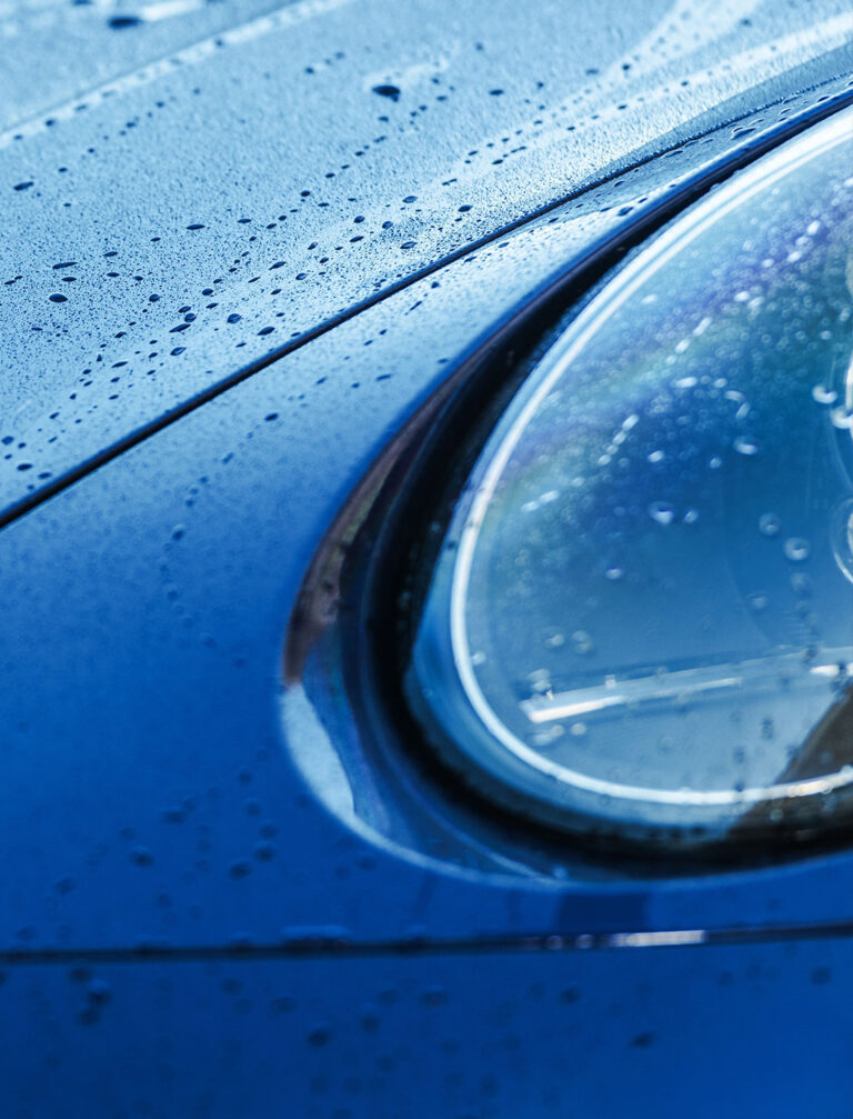 Water beading on a glossy vehicle panel